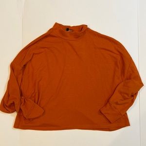 Orange Mock Neck Cropped Sweater. Dolman sleeves